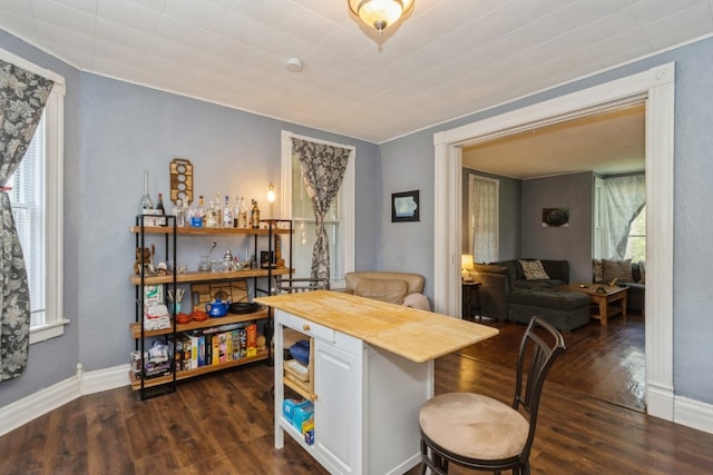 interior space with butcher block countertops, white cabinetry, and dark hardwood / wood-style floors