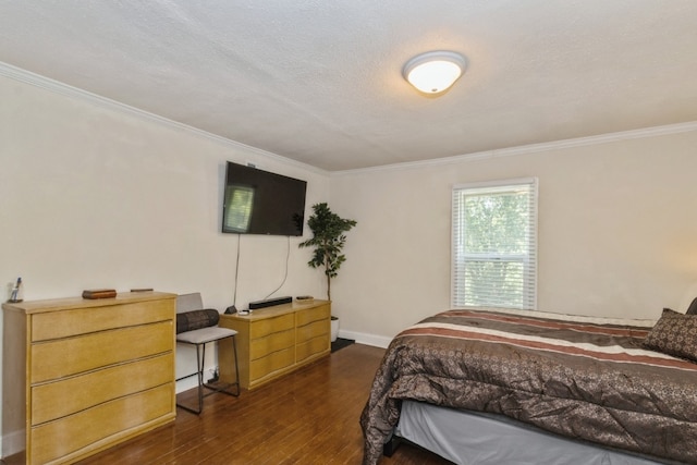 bedroom with a textured ceiling, dark wood-type flooring, and ornamental molding