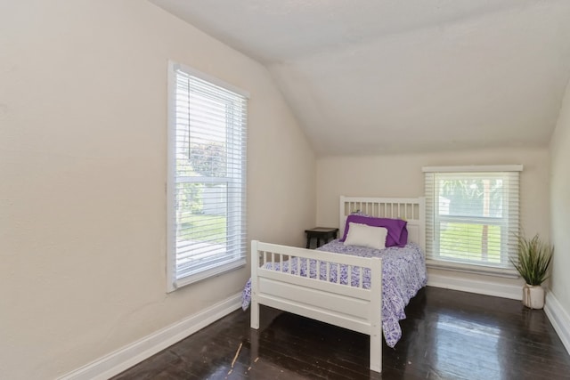 bedroom featuring lofted ceiling and hardwood / wood-style floors