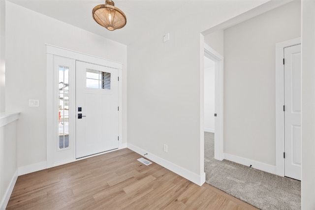 entrance foyer with light wood-style floors, visible vents, and baseboards