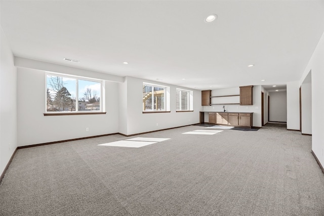 2733 Brookfield Dr, Marion, IA 52302 - unfurnished living room with light carpet, baseboards, recessed lighting, and a sink