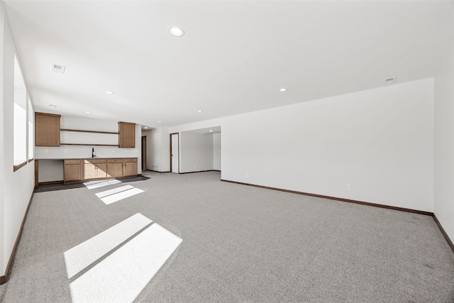 2733 Brookfield Dr, Marion, IA 52302 - unfurnished living room featuring light carpet, baseboards, recessed lighting, and a sink
