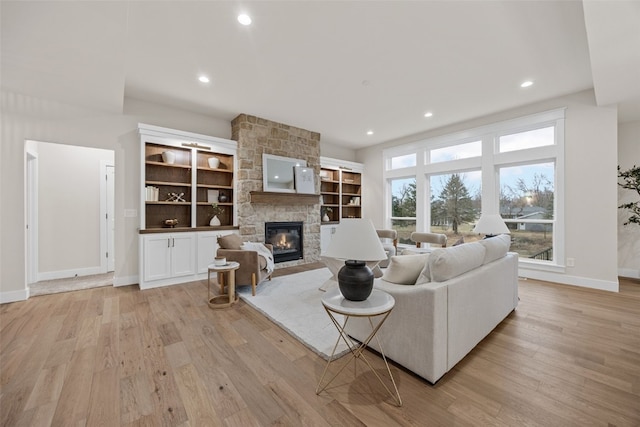 2733 Brookfield Dr, Marion, IA 52302 - living area featuring baseboards, a fireplace, light wood-style floors, and recessed lighting