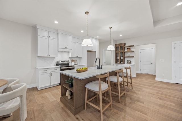 2733 Brookfield Dr, Marion, IA 52302 - kitchen with open shelves, electric range, light countertops, white cabinets, and light wood-type flooring