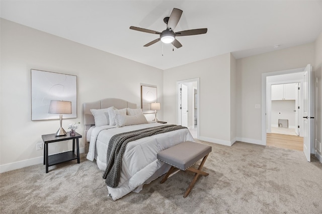 2733 Brookfield Dr, Marion, IA 52302 - carpeted bedroom with baseboards, connected bathroom, and a ceiling fan