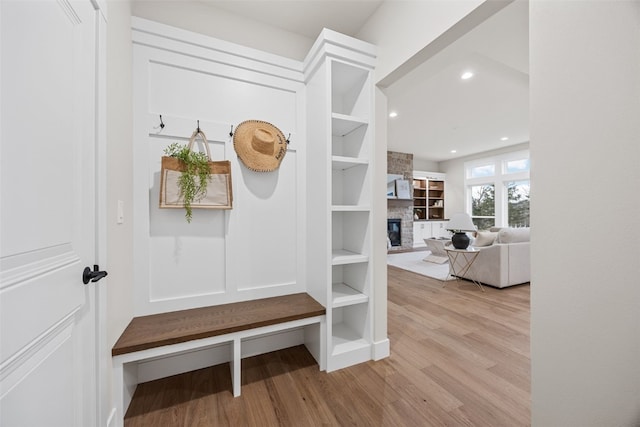2733 Brookfield Dr, Marion, IA 52302 - mudroom featuring wood finished floors, a stone fireplace, and recessed lighting