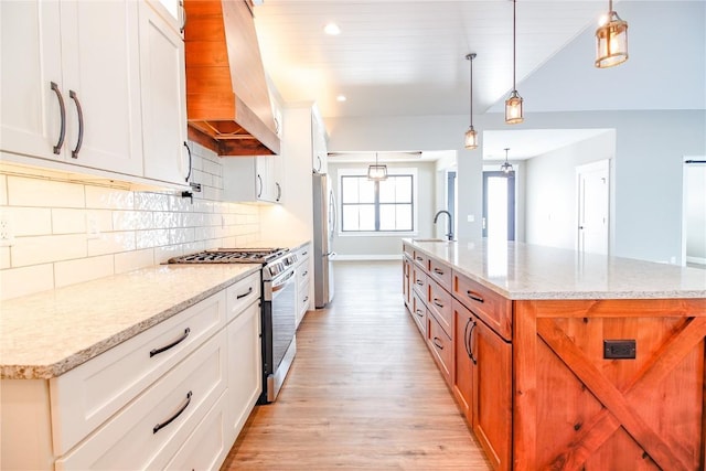 kitchen featuring white cabinets, a large island, and stainless steel appliances