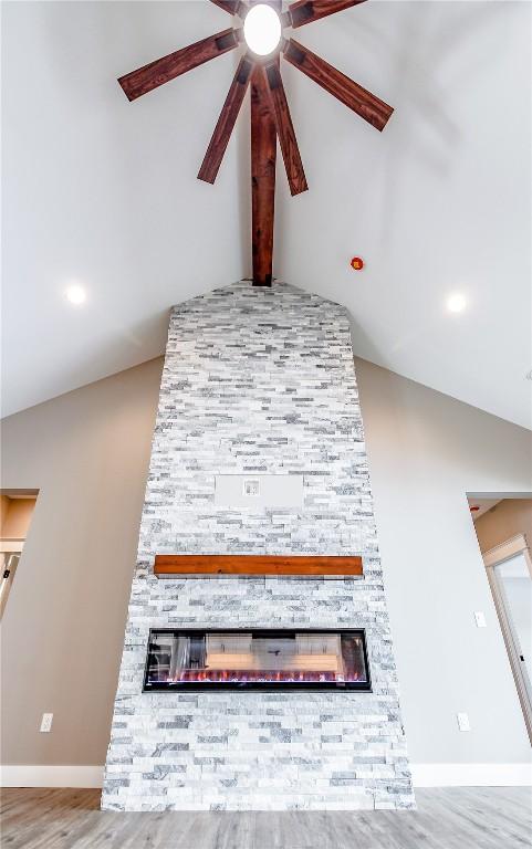 interior details featuring hardwood / wood-style floors, ceiling fan, and a fireplace