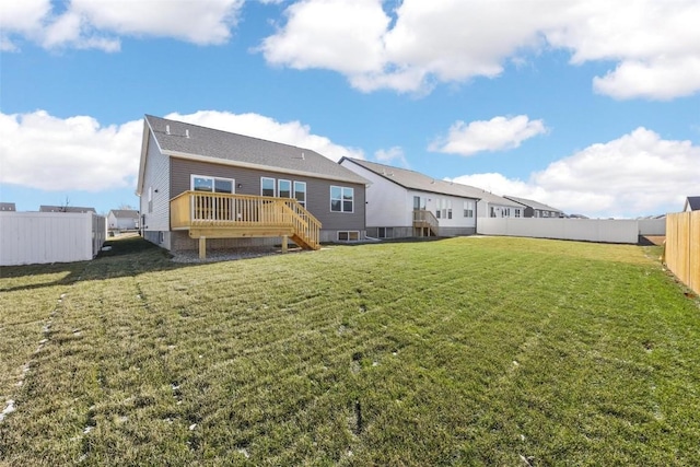 back of property featuring a lawn and a deck