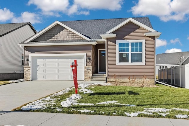 craftsman-style home featuring a front yard and a garage