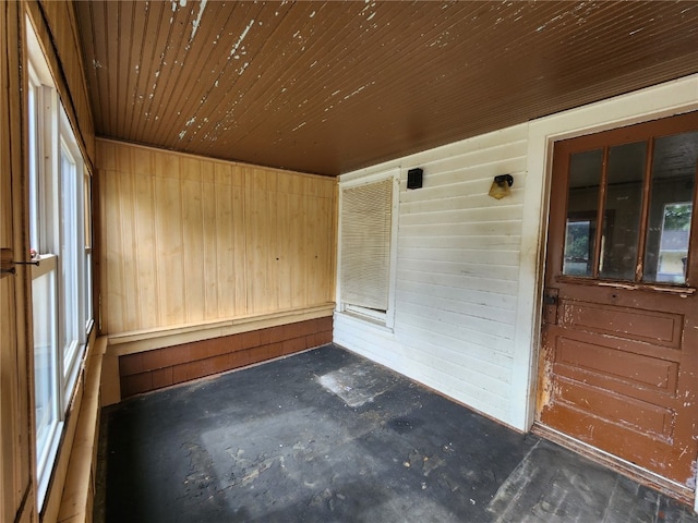 unfurnished sunroom with wooden ceiling