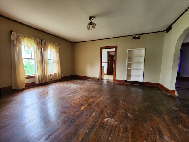 spare room featuring crown molding, hardwood / wood-style flooring, and built in shelves