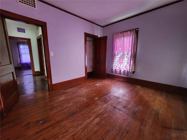 unfurnished bedroom with dark wood-type flooring and multiple windows