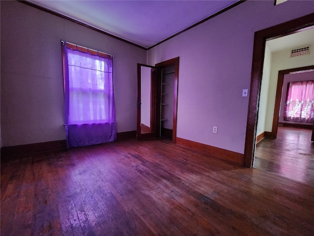 unfurnished bedroom with dark hardwood / wood-style floors