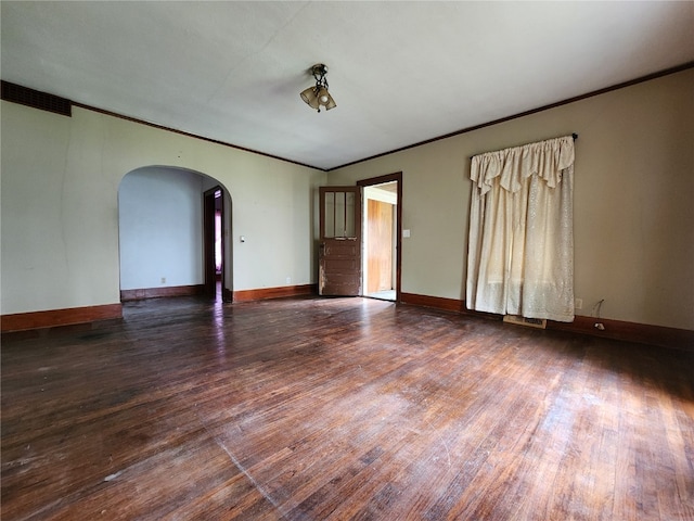 unfurnished room with dark wood-type flooring and ornamental molding