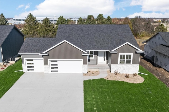 view of front of home with a garage and a front lawn