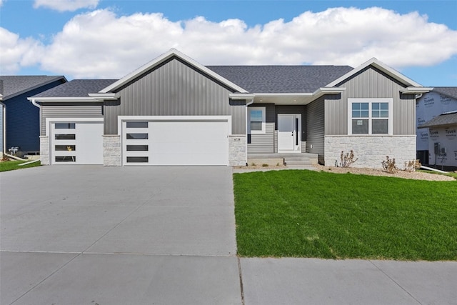 view of front of property with a garage and a front yard