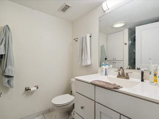 bathroom with tile flooring, oversized vanity, and toilet