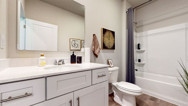 full bathroom featuring wood-type flooring, toilet, tub / shower combination, and vanity