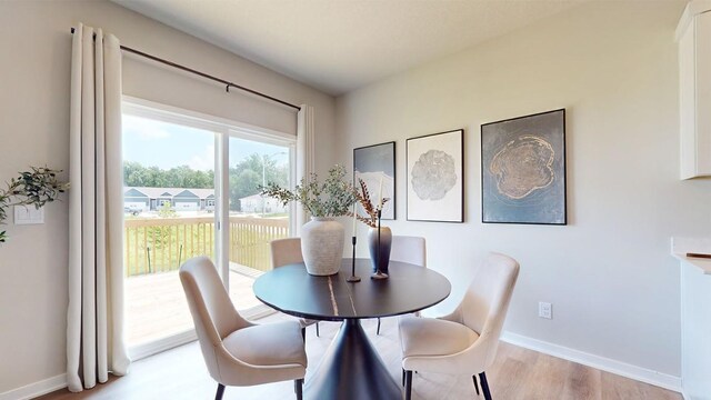 dining area with light hardwood / wood-style flooring