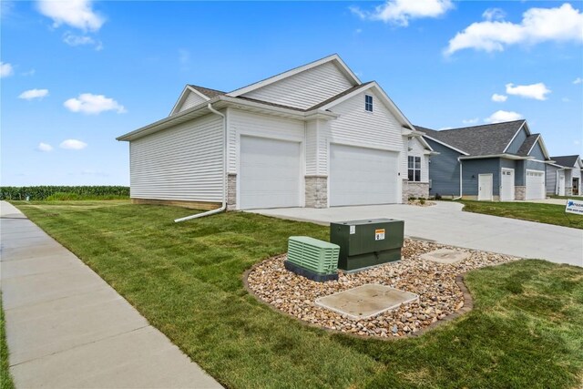 view of home's exterior featuring a yard and a garage