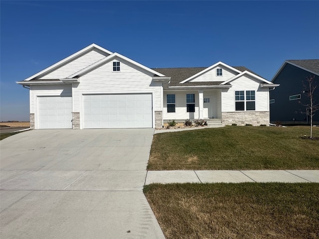 view of front of property with a front lawn and a garage