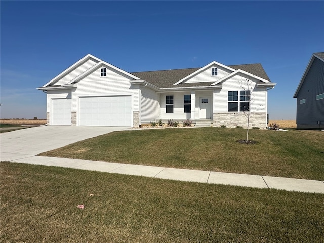 view of front of property with a garage and a front lawn