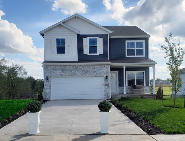 view of front of property with a garage, a front yard, and a porch