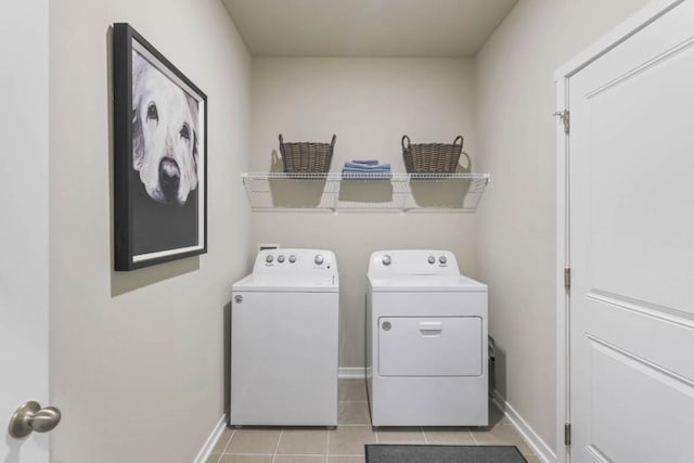 laundry room featuring washer and clothes dryer and light tile patterned flooring