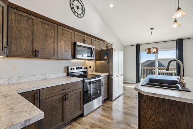 kitchen with sink, dark brown cabinets, and appliances with stainless steel finishes