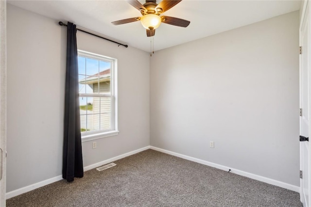 spare room featuring carpet flooring and ceiling fan