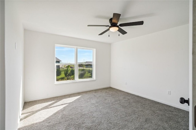 spare room featuring ceiling fan and carpet floors