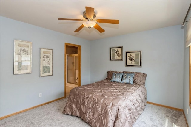 carpeted bedroom featuring ceiling fan and ensuite bath