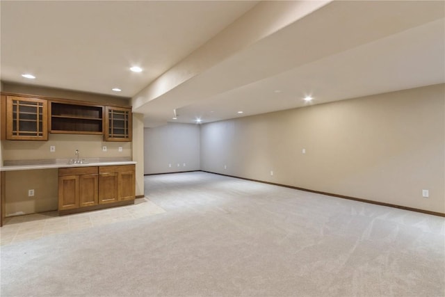 kitchen featuring light colored carpet and sink