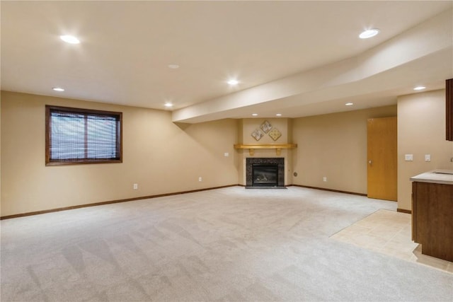 unfurnished living room with a tile fireplace and light carpet