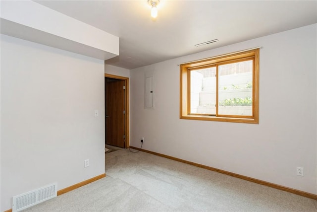 carpeted empty room with electric panel