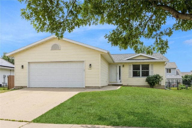 ranch-style home with a front yard and a garage