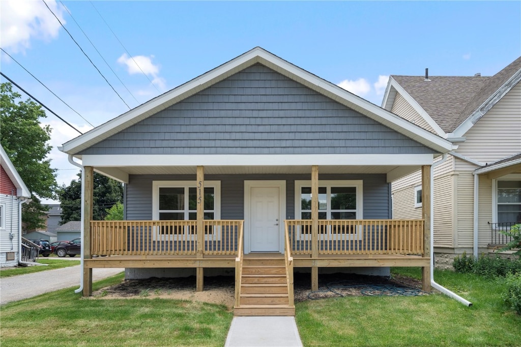 bungalow with a front lawn and a porch