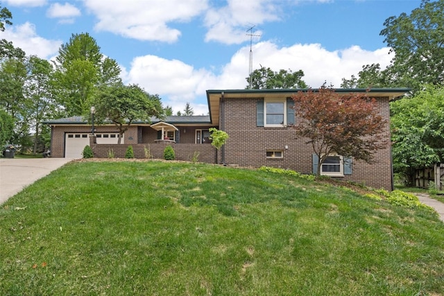 tri-level home featuring a garage and a front lawn