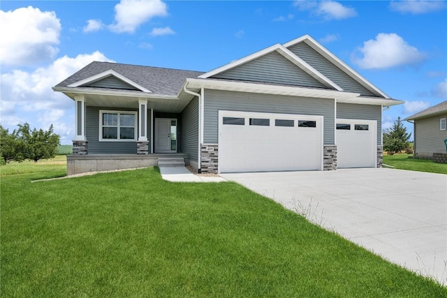 craftsman-style home featuring a garage and a front lawn