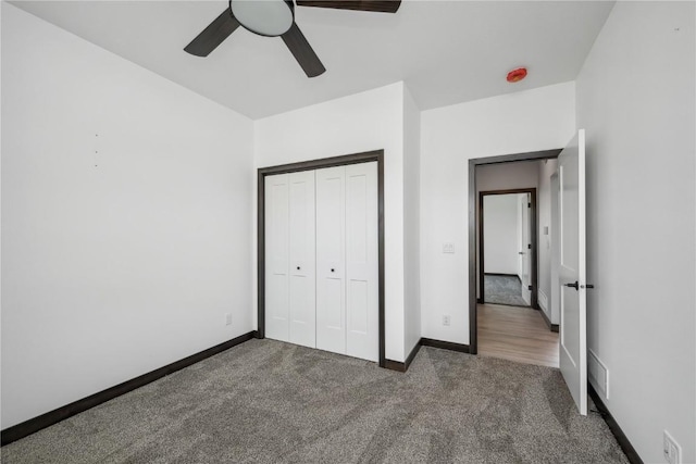 unfurnished bedroom featuring carpet flooring, a closet, and ceiling fan