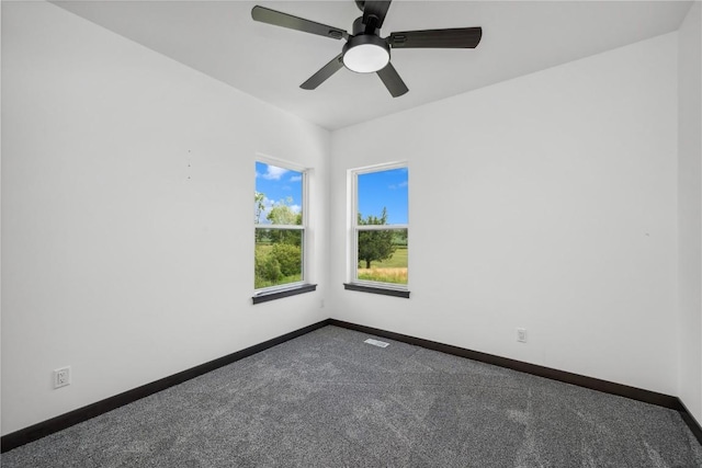 empty room featuring carpet and ceiling fan