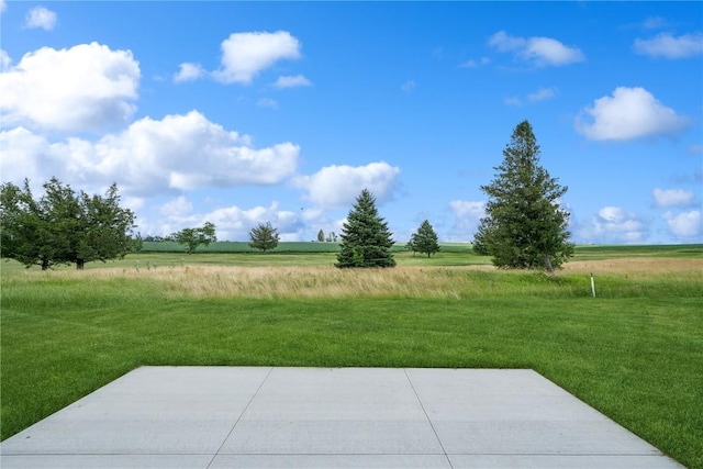 view of yard featuring a patio and a rural view