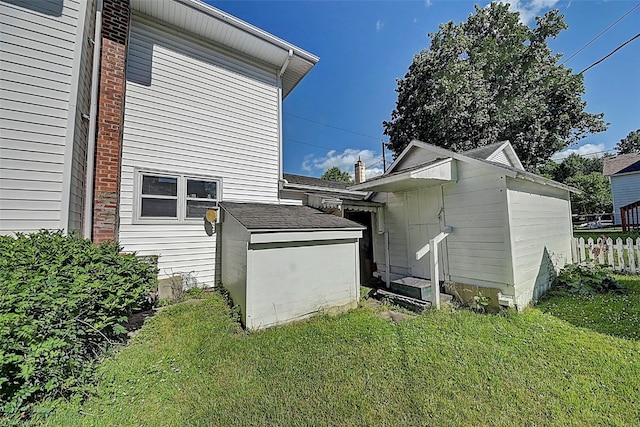 view of side of home with a yard