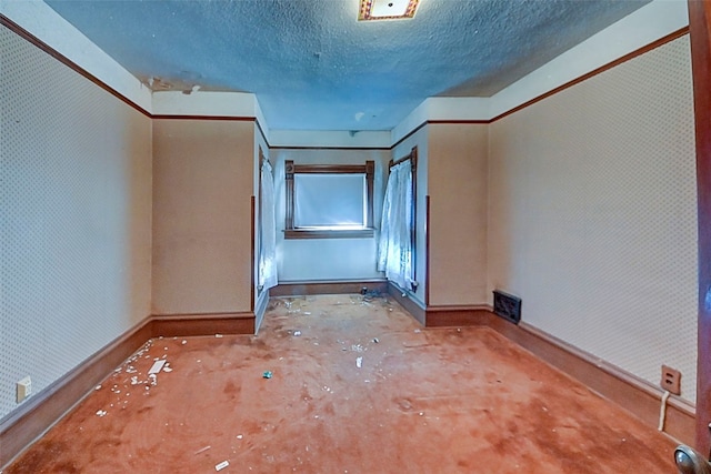 spare room with a textured ceiling