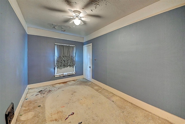 spare room featuring a textured ceiling and ceiling fan