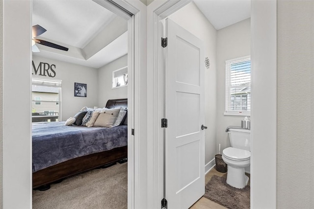 bedroom featuring ceiling fan, baseboards, and light carpet