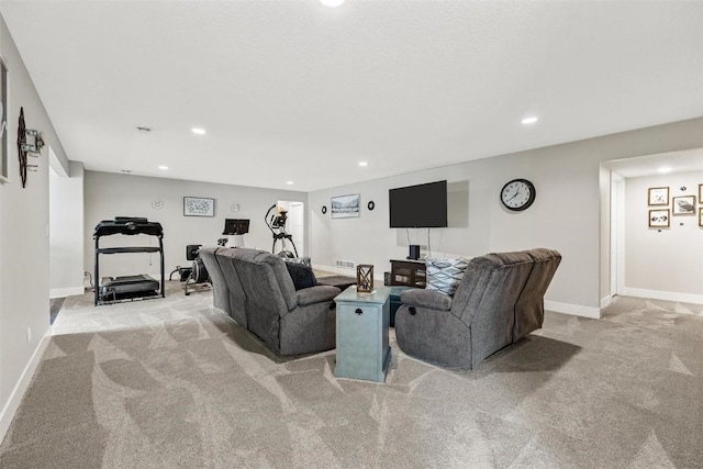 living room featuring recessed lighting, visible vents, baseboards, and light colored carpet