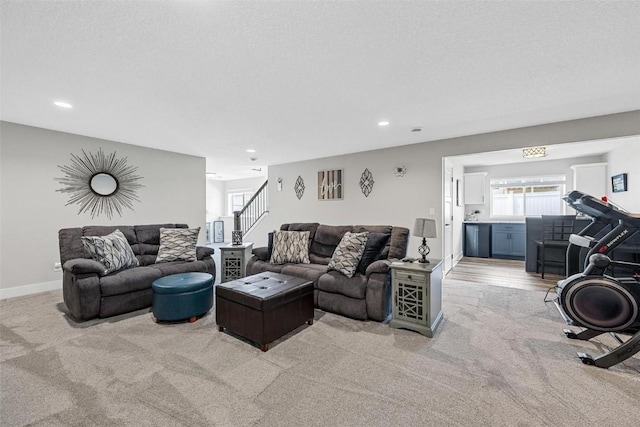 carpeted living room featuring a textured ceiling