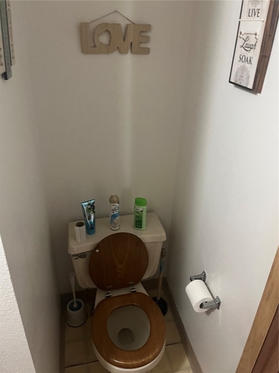 bathroom with toilet and tile patterned floors